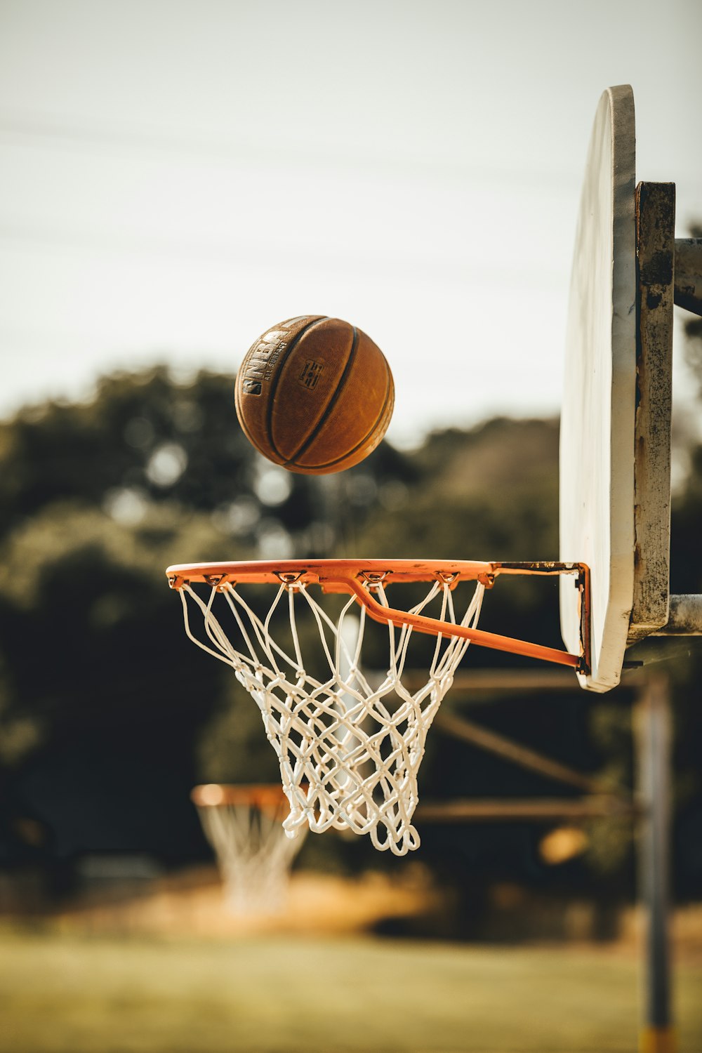 Ball at the rim β NBA preseason symbol